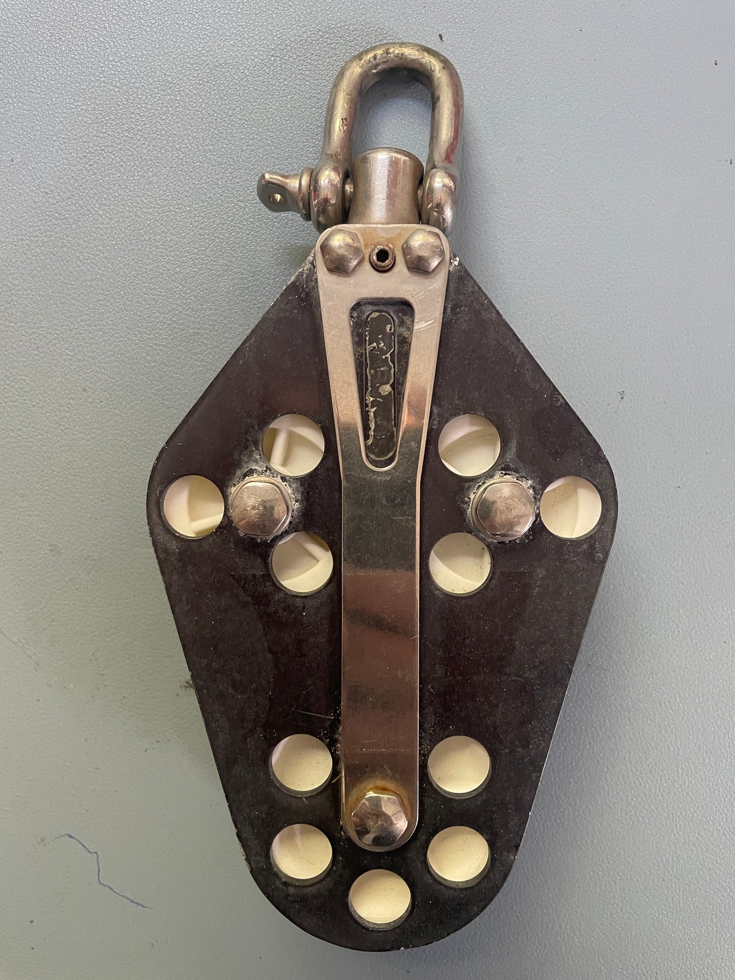 Metal device with white knobs on a gray background