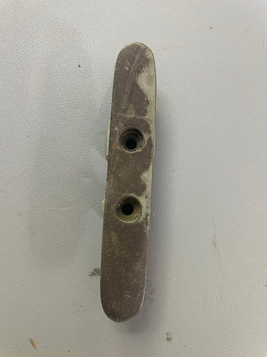 Bronze metal bracket with two holes on a white background