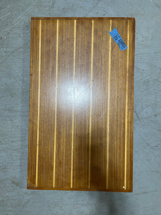 Wooden cutting board with a blue label on a gray surface