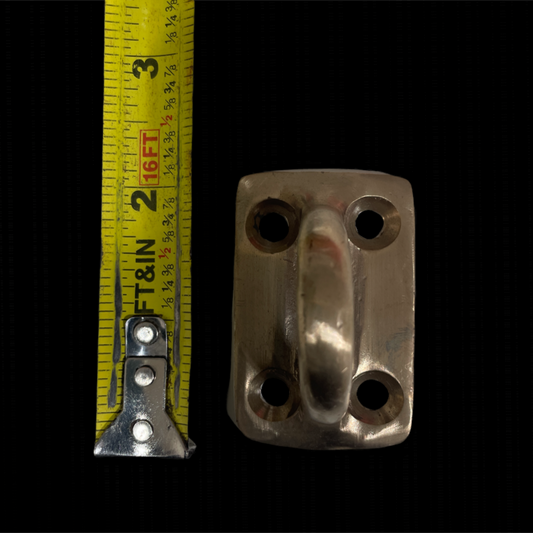 Metal latch with a measuring tape on a black background