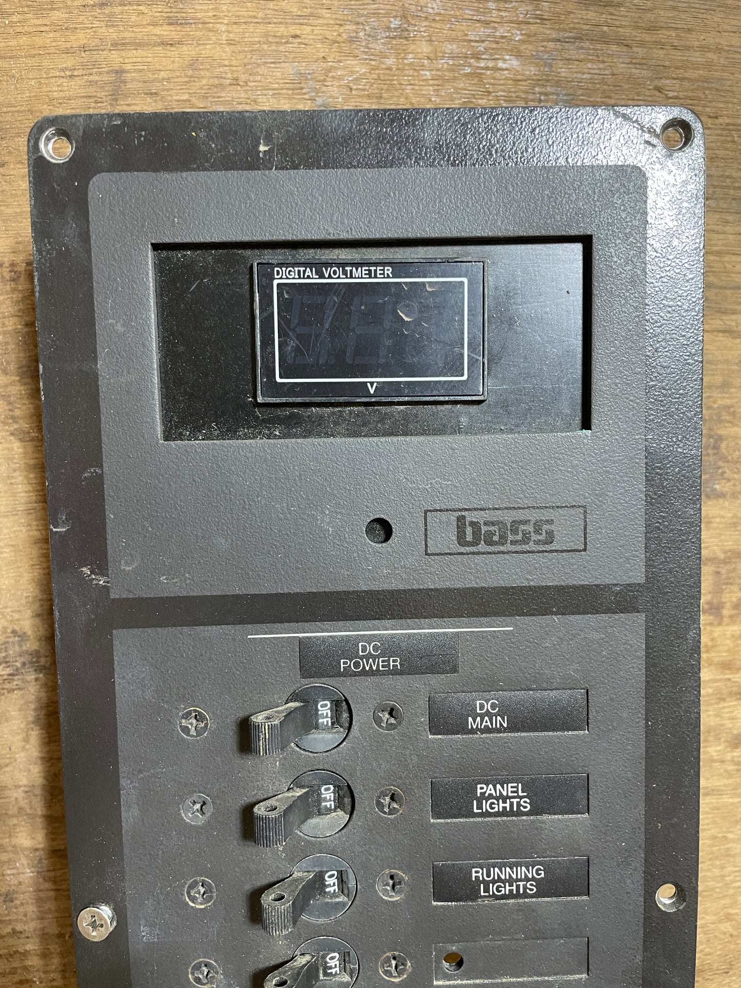Control panel with switches and labels on a wooden surface