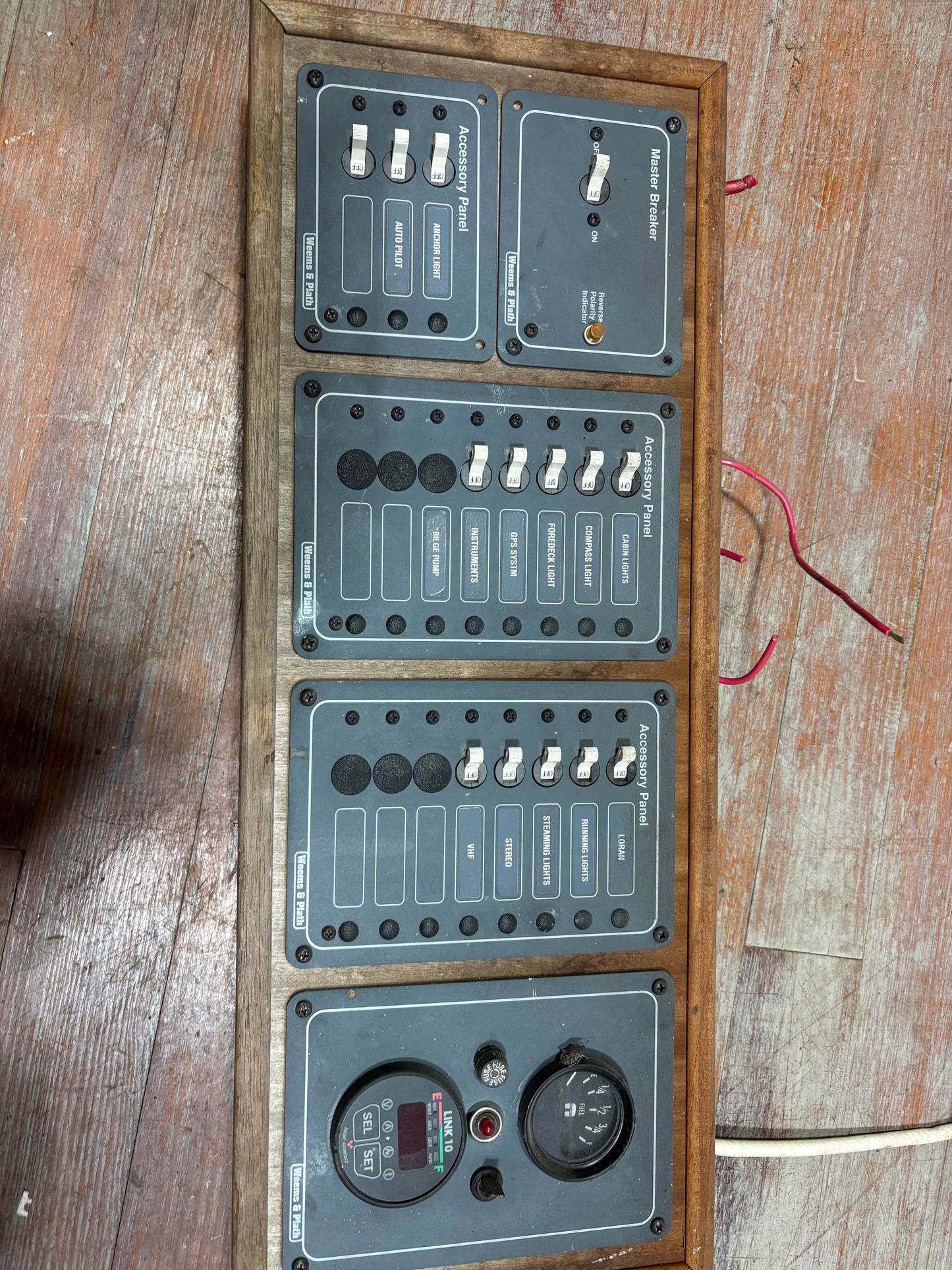 Electrical panel with multiple switches and connectors on a wooden surface
