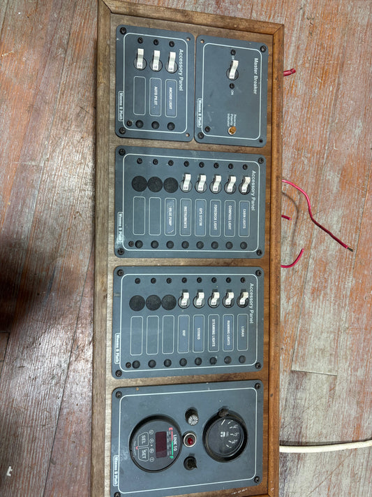 Electrical panel with multiple switches and connectors on a wooden surface