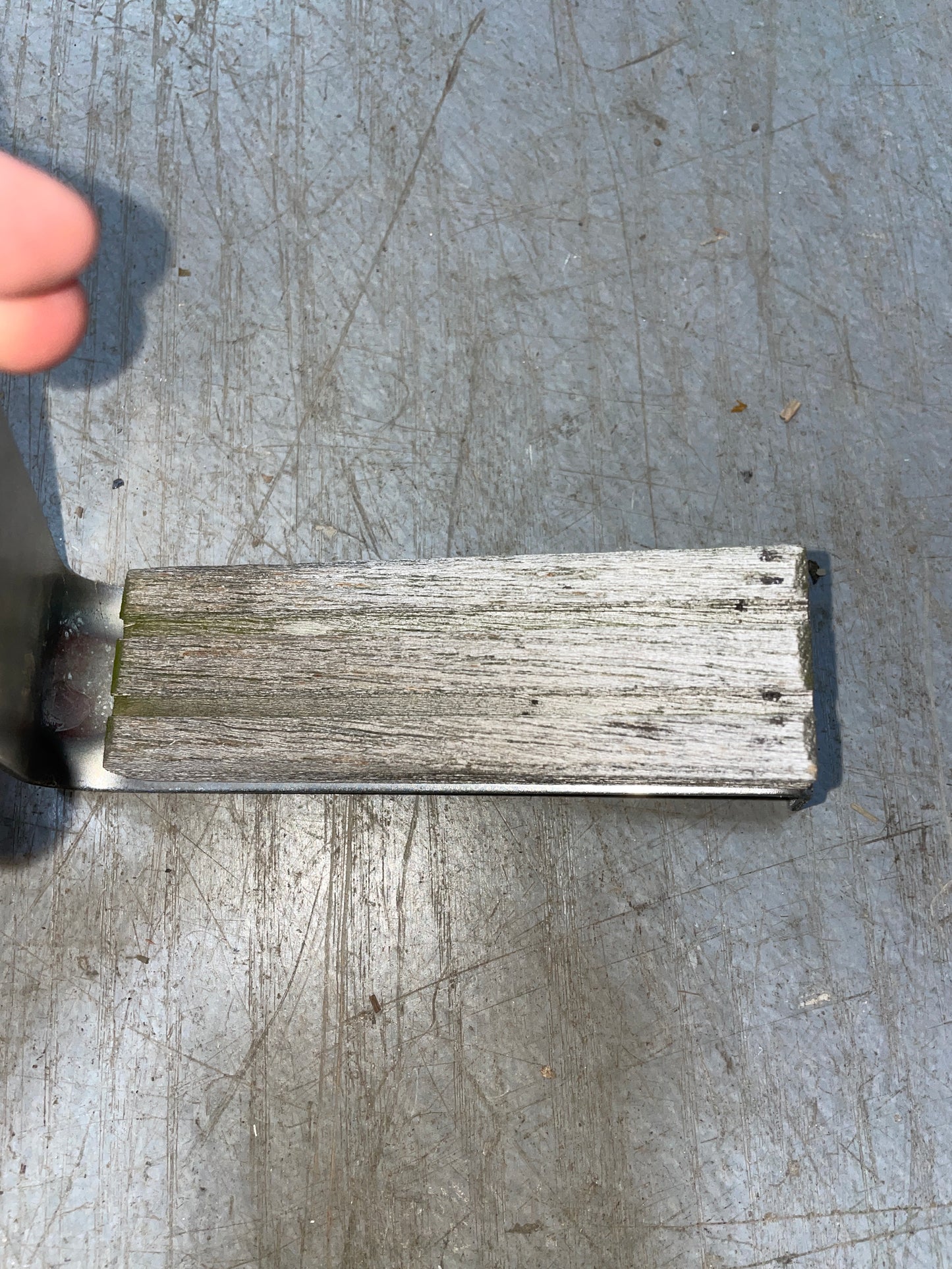 Rectangular metal block on a textured metal surface